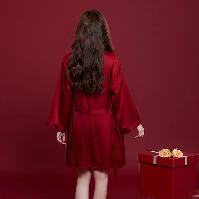 Red long-sleeved ice silk sleepwear set for a man and woman laid out flat.