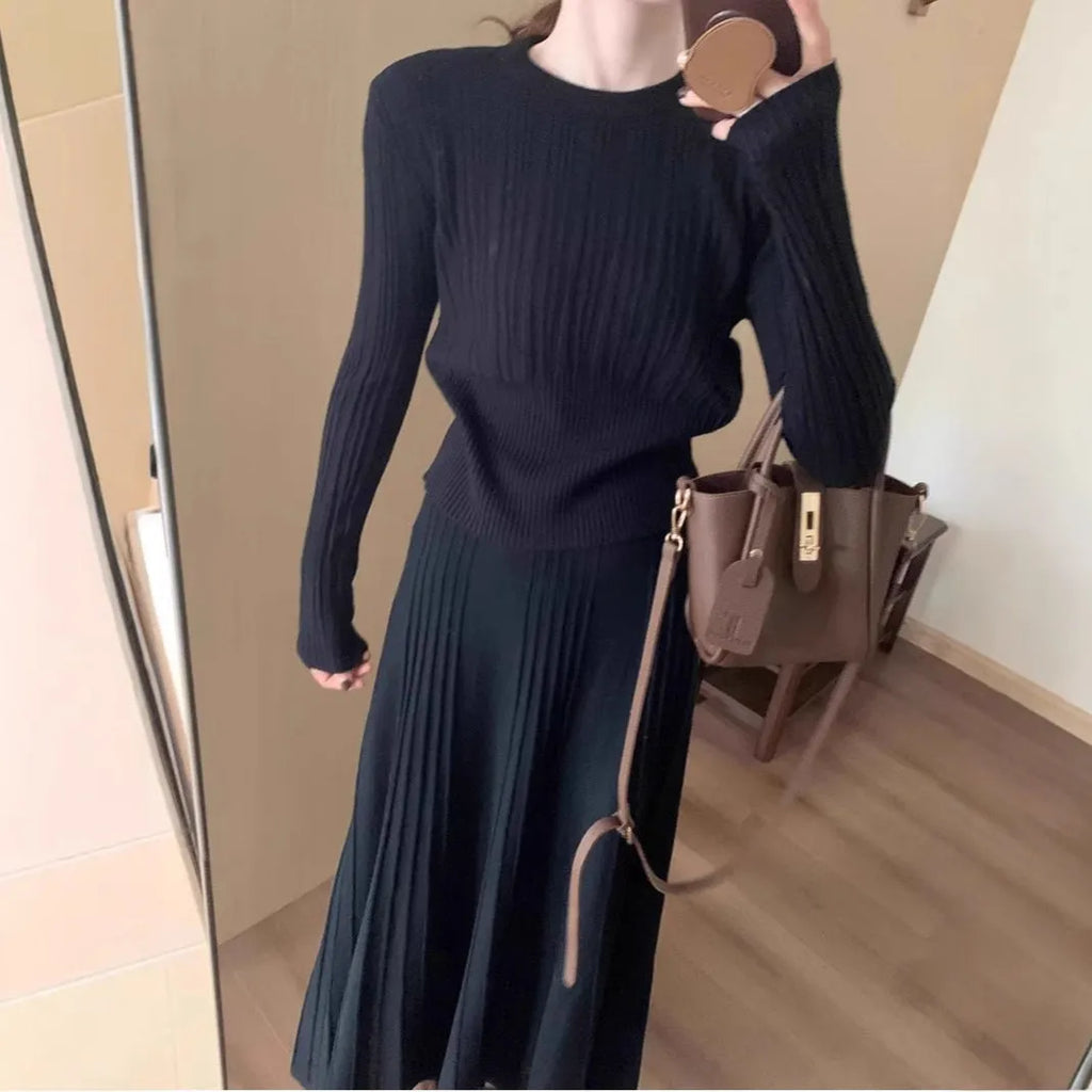 Dark grey knitted two-piece dress suit with 3D pattern, showing sweater and skirt.
