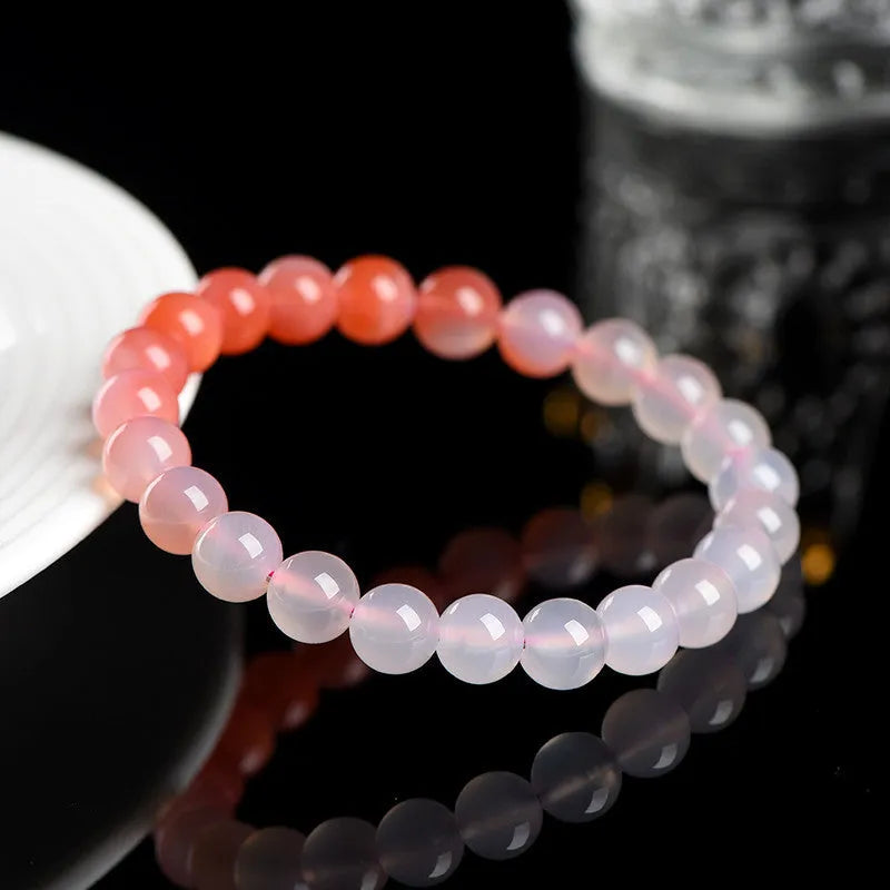 Natural gradient Yanyuan agate bracelet with geometric beads on a wrist, showing salt source colour variation.