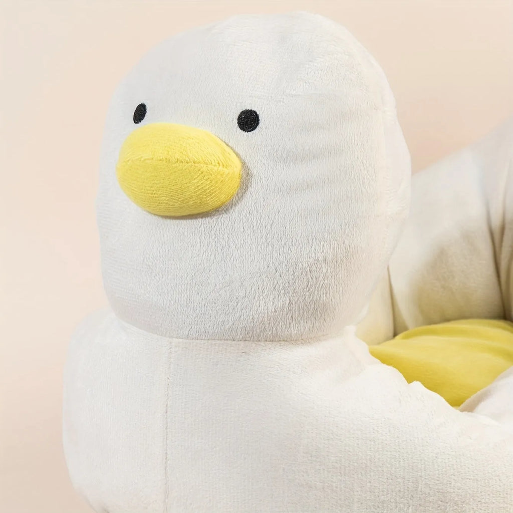 Blue duck-shaped fluffy pet bed for small dogs and cats on a wooden floor.