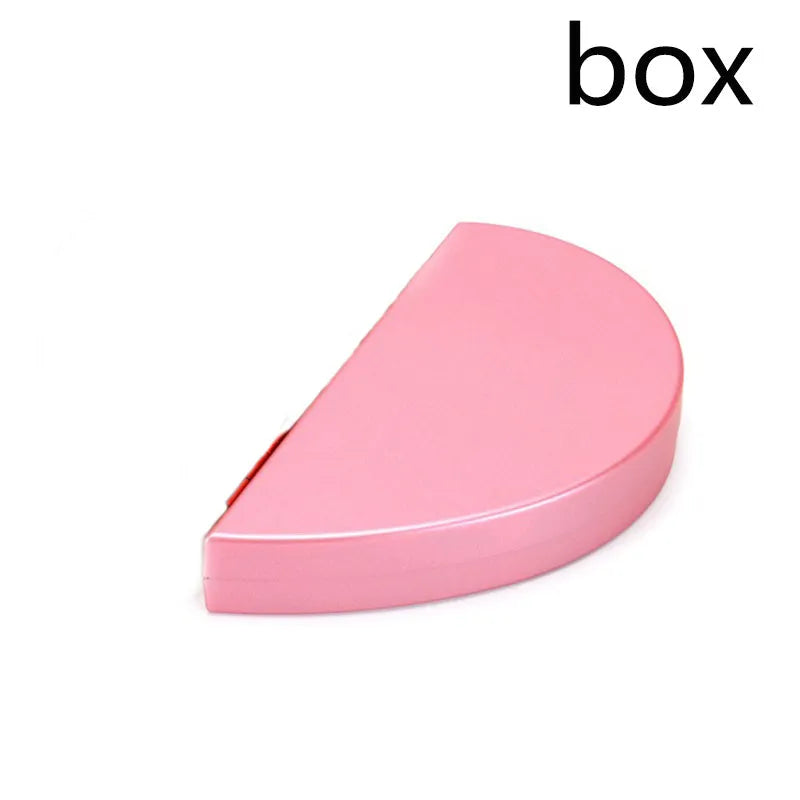 Red plastic heart-shaped rotating ring box with rose decoration inside white storage case