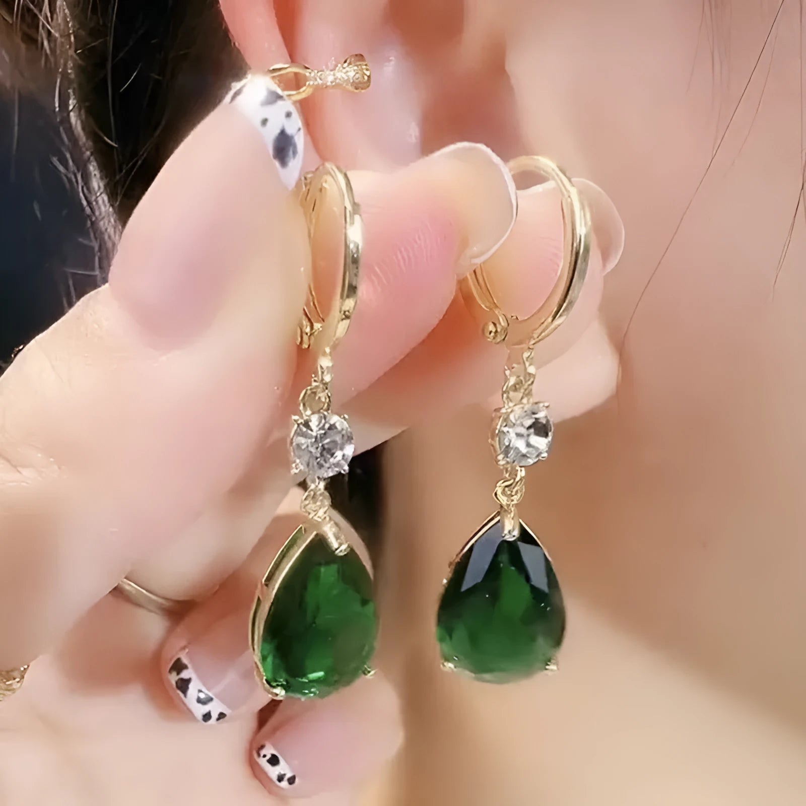 Green geometric teardrop alloy earrings on a white background