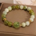 Xiuyan jade green women's bracelet with sweet Mori style design on a wrist.
