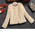 Women's short-length faux fur top in beige, shown on a model as part of a street fashion outfit.