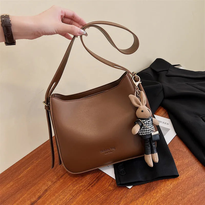 PU shoulder messenger bag in horizontal square shape with slit pocket available in black colour
