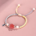 Red glass cat's paw charm bracelet with woven cord in pink or yellow for couples