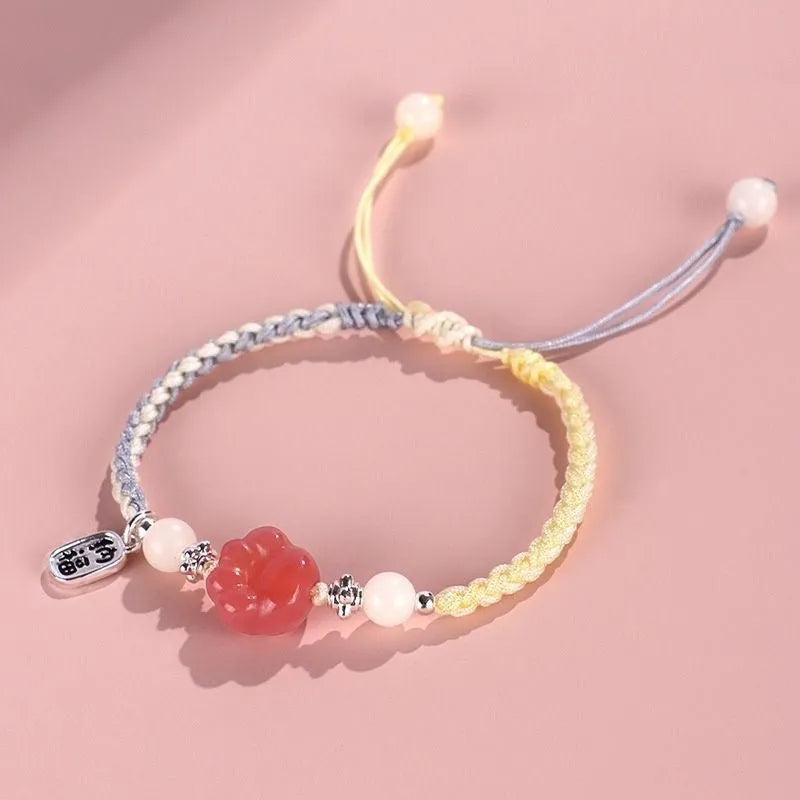 Red glass cat's paw charm bracelet with woven cord in pink or yellow for couples