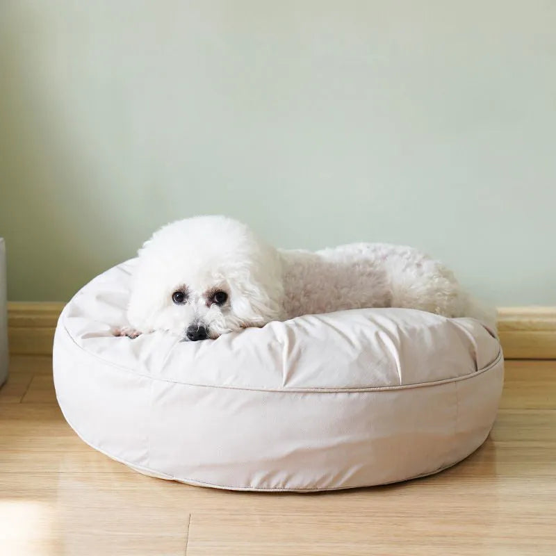 Round plush pet bed for small and medium dogs and cats, 60-80cm diameter, beige or grey, with raised rim.