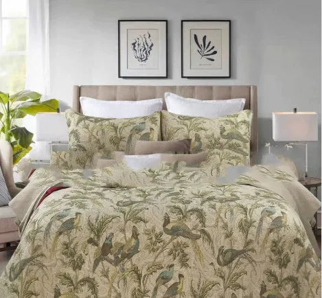 Blue American floral pattern cotton quilted bedspread set of three pieces laid on a bed.