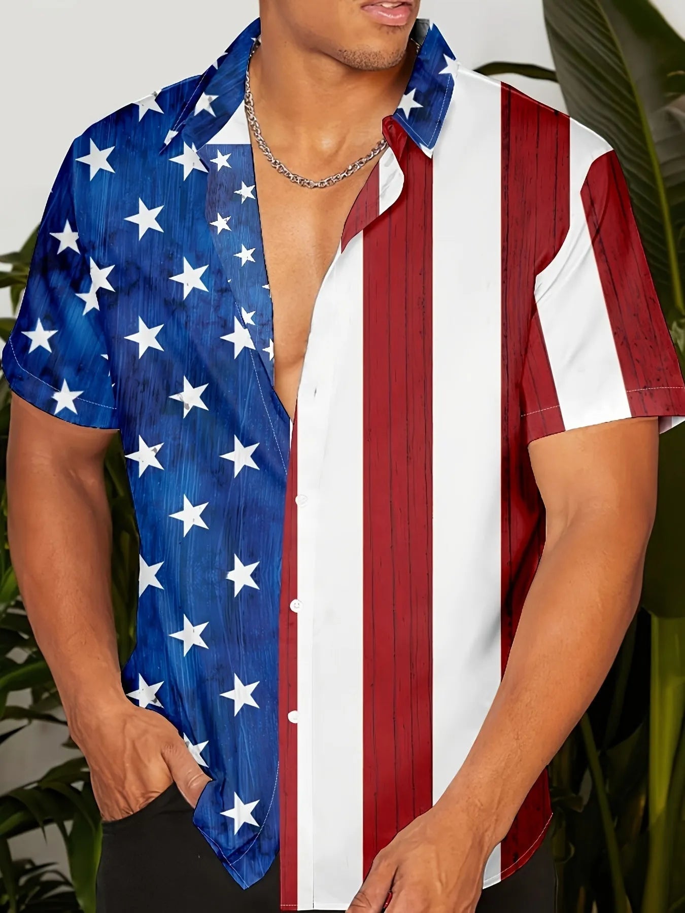 Man wearing a loose-fit floral print short sleeve cardigan-style shirt.