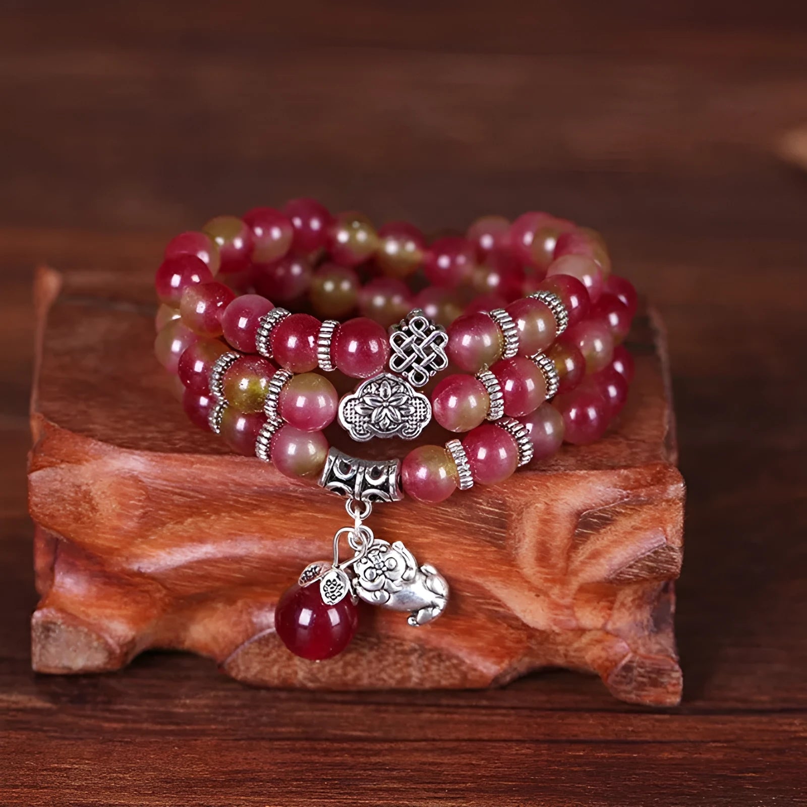 Natural watermelon crystal bracelet with Chinese knot design showing elephant style beads