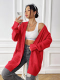 Women's loose fit acrylic cardigan with double pockets in dark green colour showing mid-length design