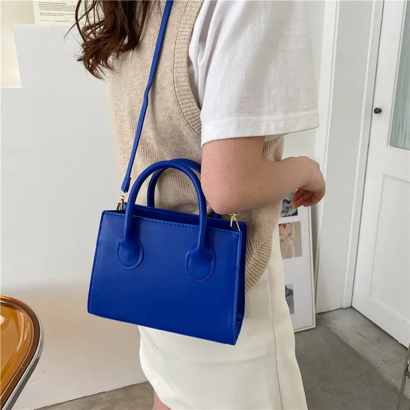 Women's black PU leather horizontal square shoulder bag with single strap and sewing line detailing