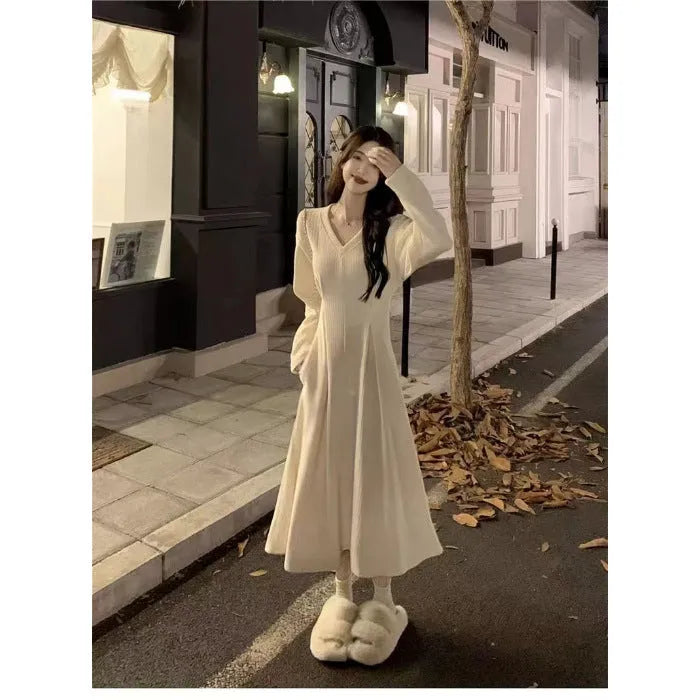 Women's knitted V-neck dress with princess sleeves and long skirt in Milky White or Black.