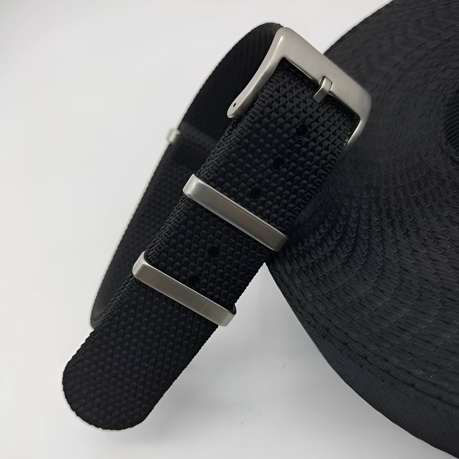 Nylon integrated watch strap in army green colour showing textile weave and buckle.