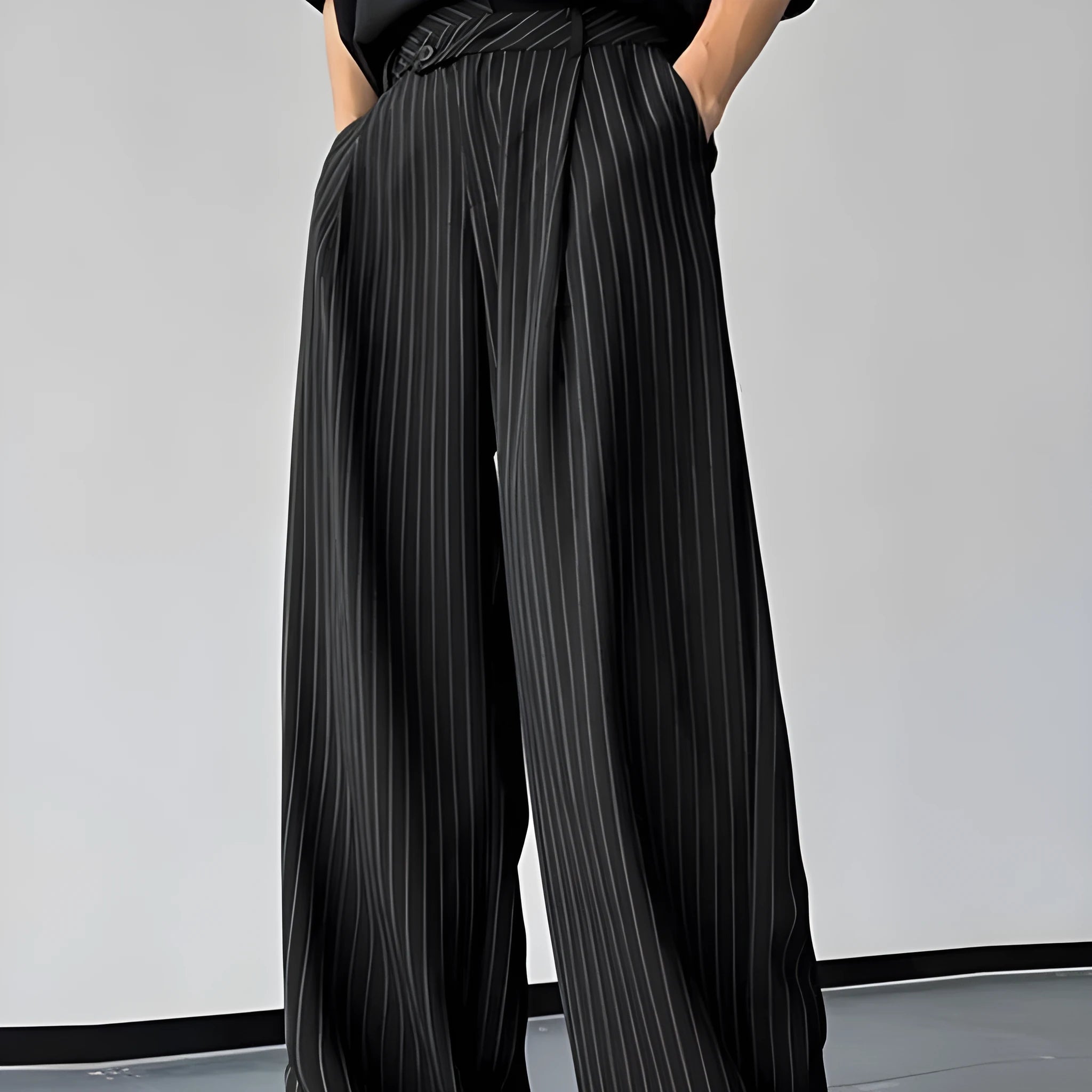 Men's black vertical striped pleated casual trousers showing elastic fabric detail