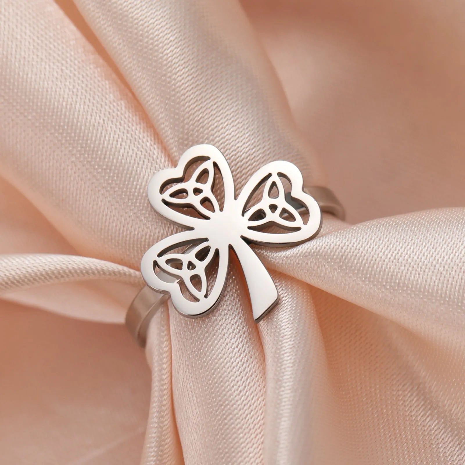 Stainless steel hollow ring with lucky symbol design in gold or steel finish