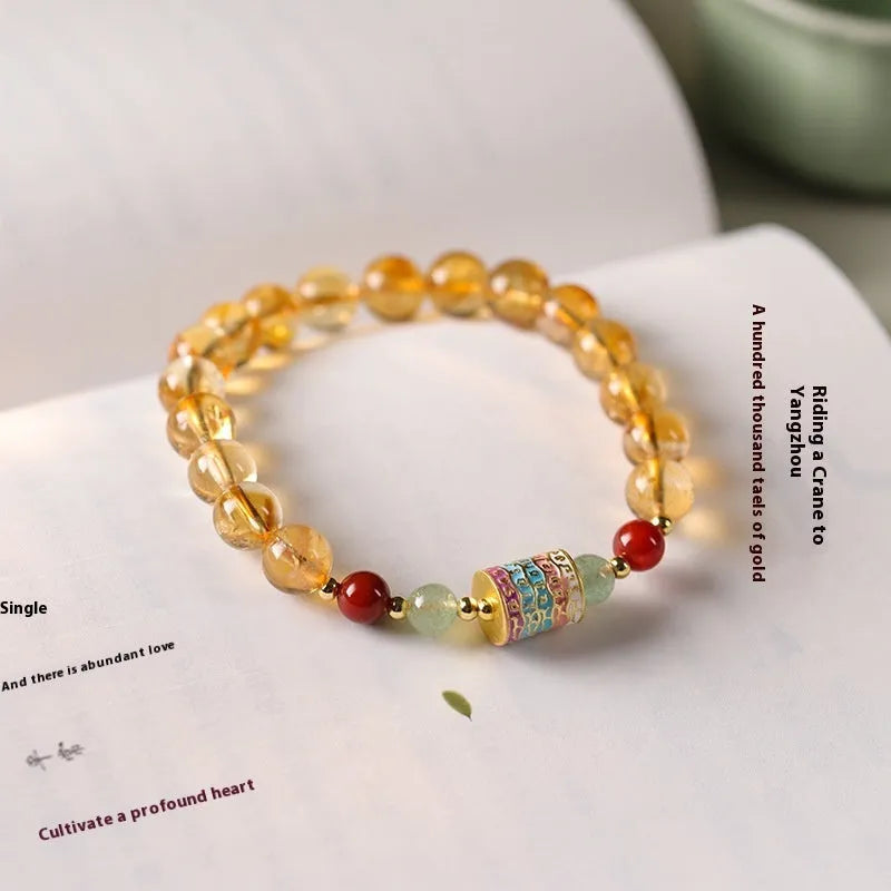Yellow citrine bracelet with prayer wheel elements on 8mm round beads