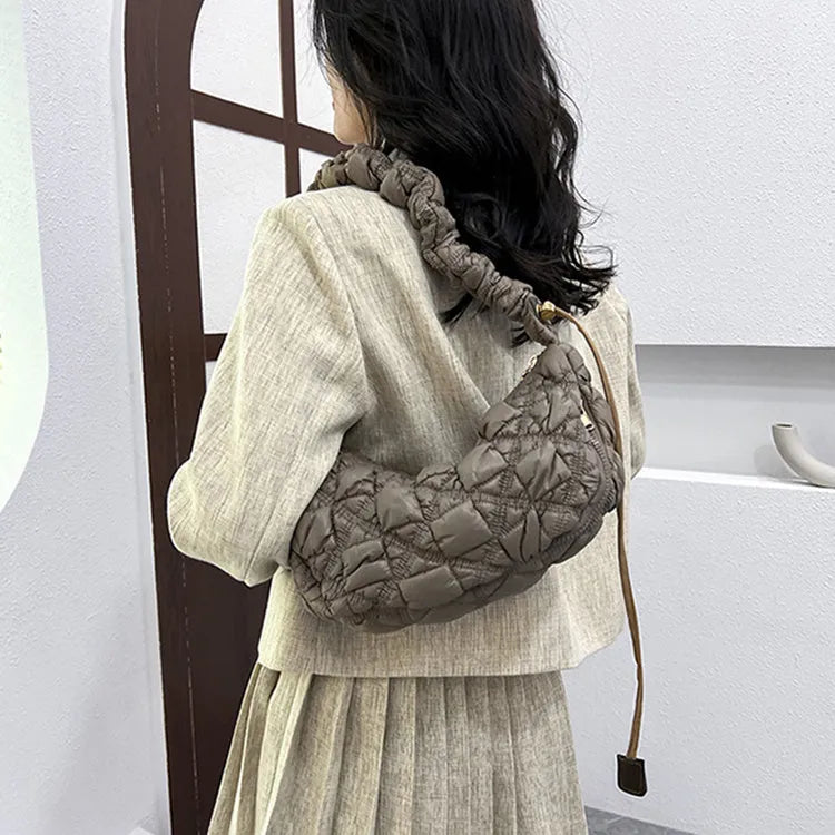 Women's nylon messenger bag in solid colour with adjustable shoulder strap, shown in beige