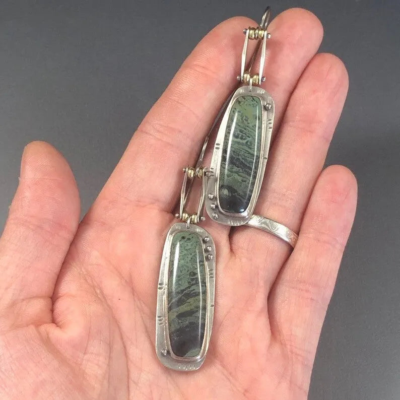 A pair of simple geometric drop earrings with a grey and white marble pattern on an alloy background.