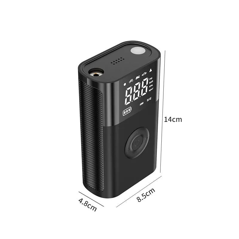 Black handheld wireless digital tyre inflator with LCD screen, LED light and multiple nozzle attachments on a table.