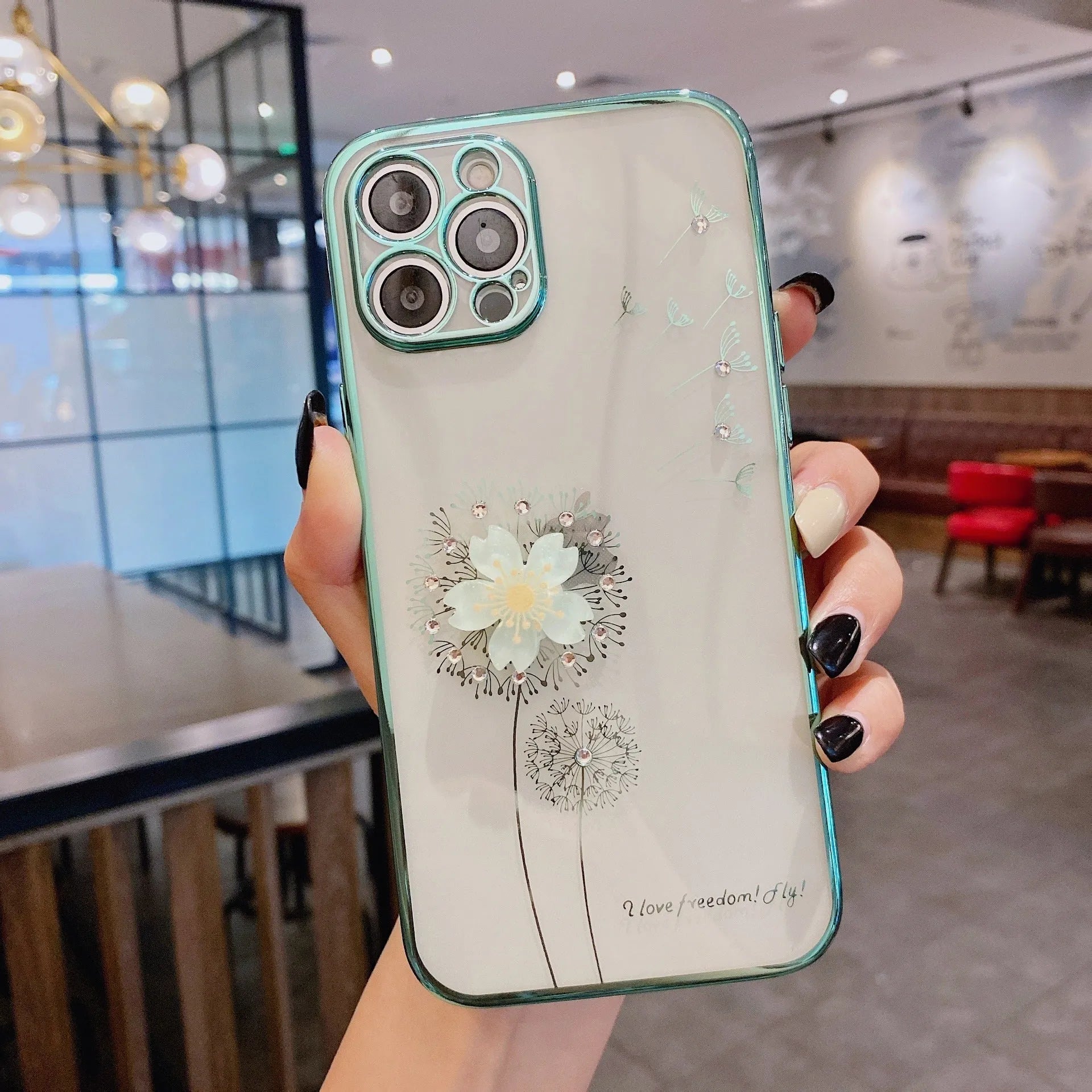 Green iPhone case with a 3D white flower spin stand on the back, showing the built-in screen protector.
