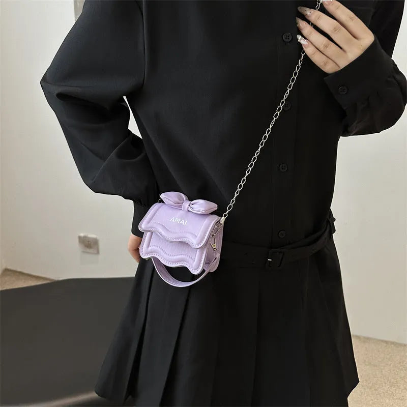 Mini crossbody bag in PU leather with adjustable strap shown in seven colour options