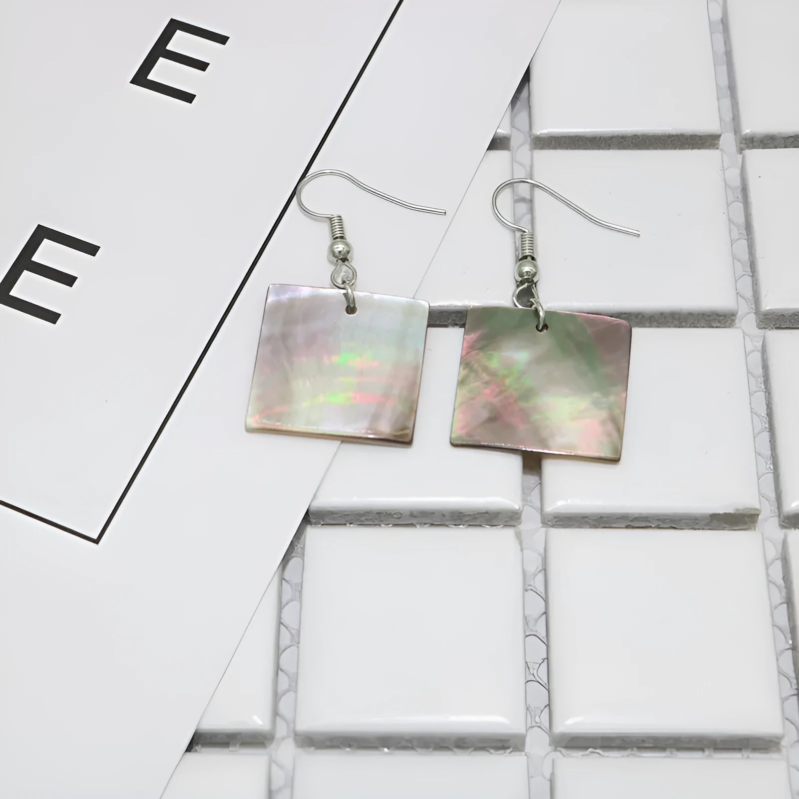Women's geometric shell earrings showing rectangular and square shapes with natural shell material texture