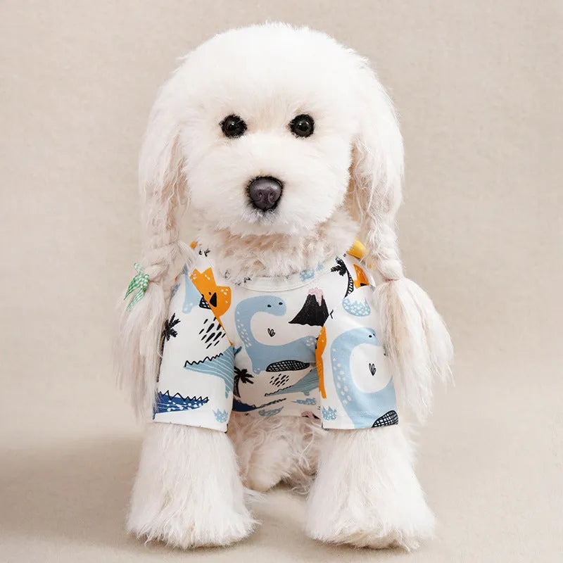 A small dog wearing a colourful, printed polyester t-shirt, showing the full chest design and fit.