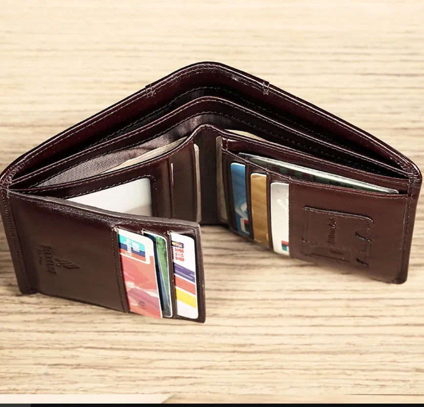 Men's black leather wallet open to show internal card slots, coin pocket, and banknote compartment.