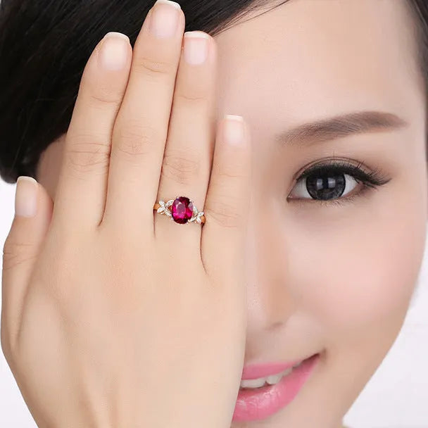 Women's butterfly ring with heart-shaped design in copper and rose gold plating, showing blue and red colour options
