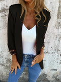 Woman wearing a slim fit black blazer with a bold 3D cheetah animal print pattern.