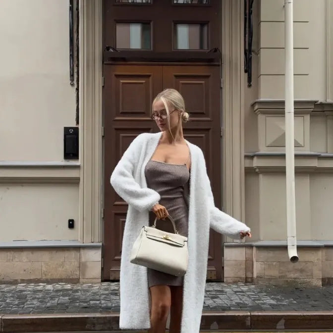 Long white women's cardigan jacket with thick knit and open front.