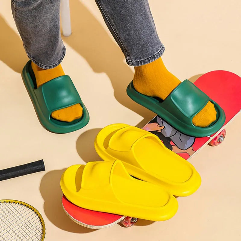 Pair of thick-soled EVA flip-flop slippers in a chosen colour on a bathroom floor.