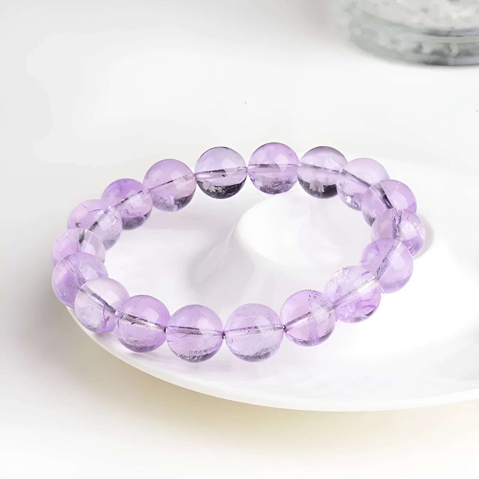 Lavender round amethyst crystal bead bracelet with water ripple design on a wrist.