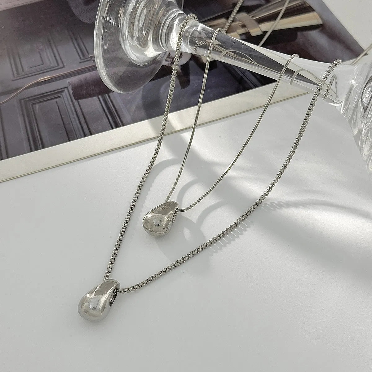 Women's geometric oval water drop pendant necklace in gold or white K finish on iron chain