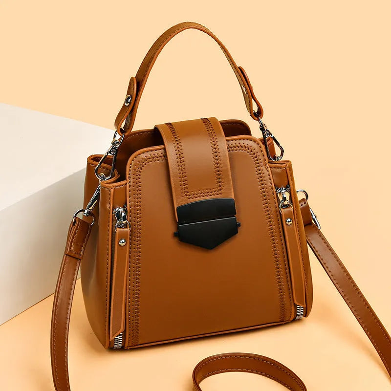 Small square vertical handbag in soft PU leather with textured stitching, shown in multiple colour options.