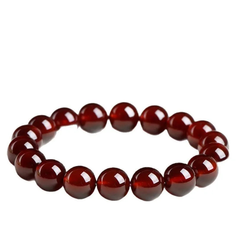 Natural orange red garnet ball bracelet with Ruyi design elements on crystal beads