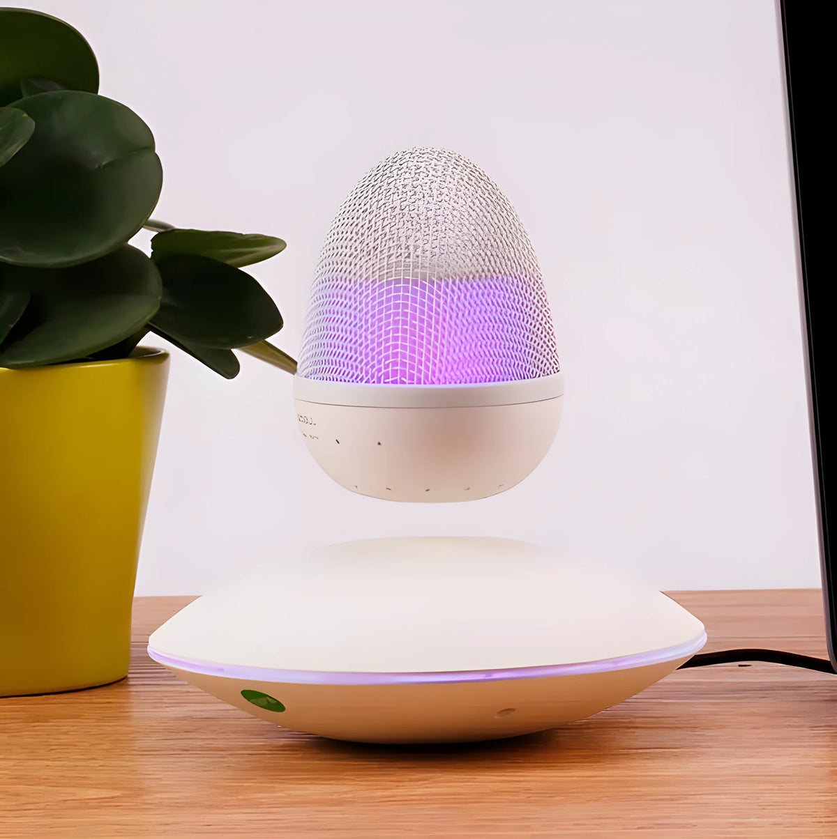 Newest levitating floating speaker in black with magnetic suspension on base showing wireless bluetooth connectivity for home decor