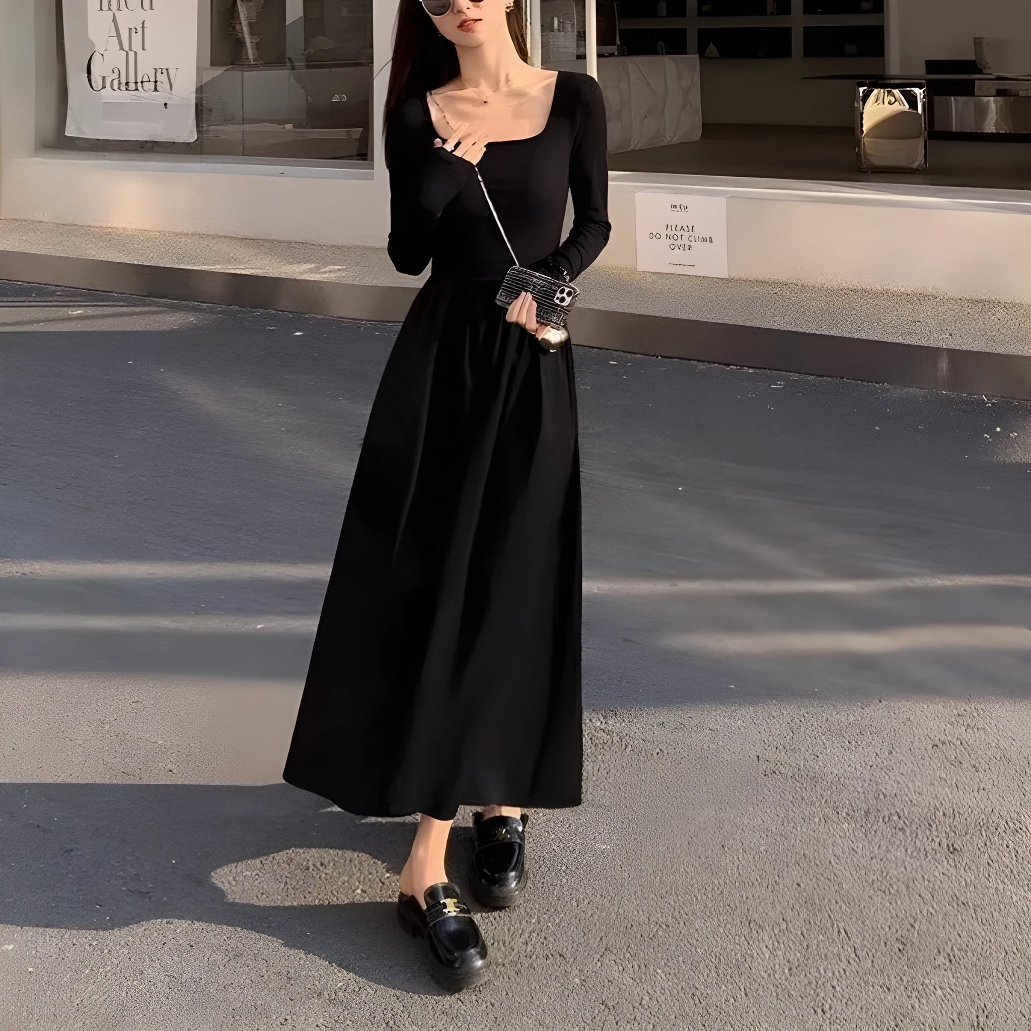 Black square collar knitted A-line dress with long sleeves and an elastic waist on a model.