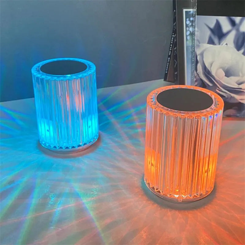 Compact acrylic crystal LED table lamp with RGB colours and remote control on a desk