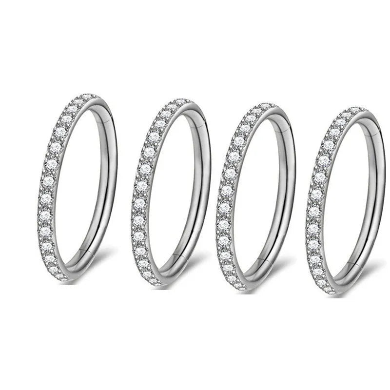 A round stainless steel seamless nose ring on a grey background, shown in a gold plated finish.