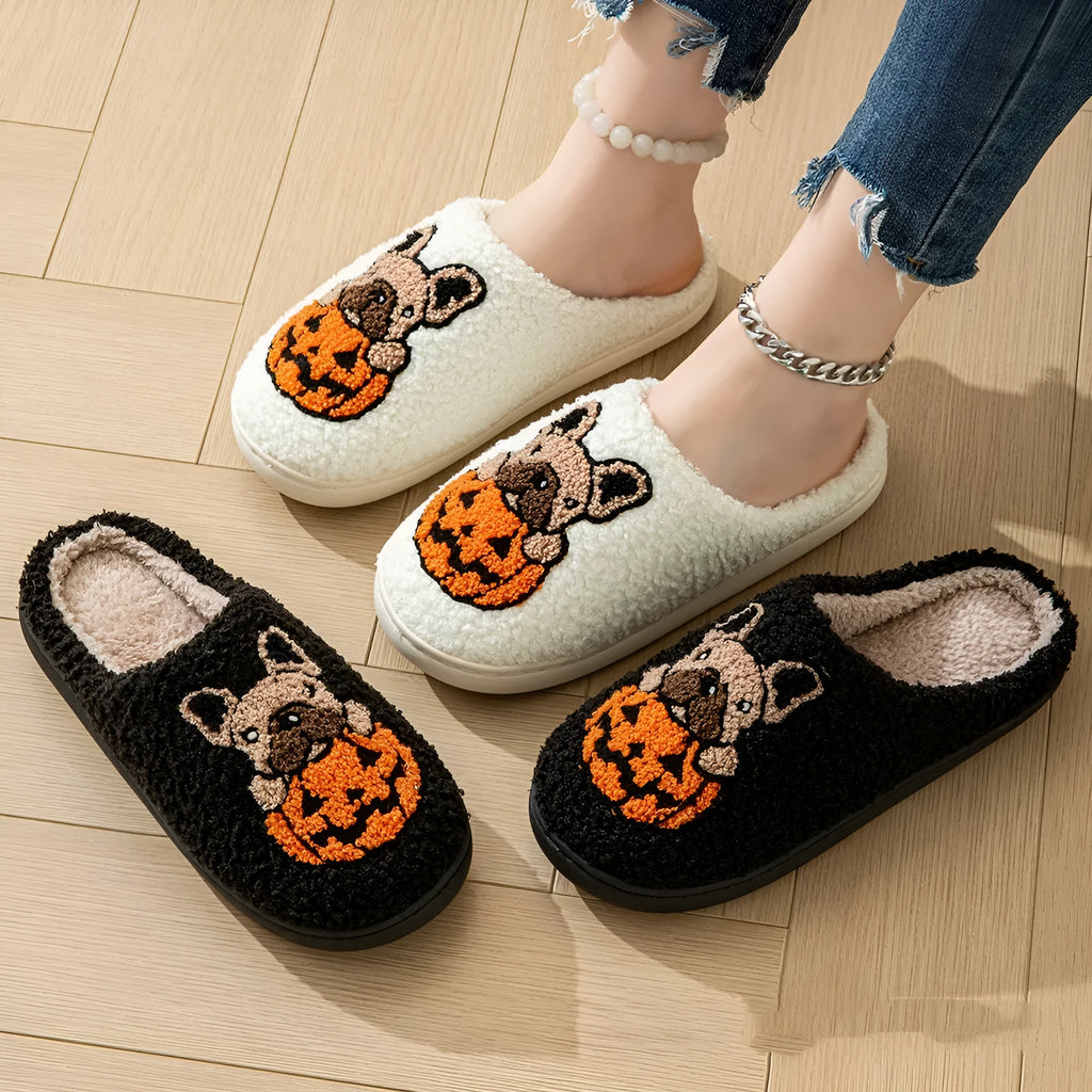 Black Halloween slippers with pumpkin design featuring soft plush upper and non-slip rubber soles.