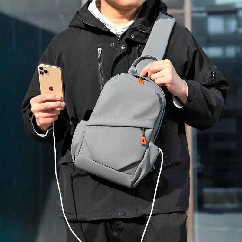 Men's black polyester crossbody bag worn on single shoulder with adjustable strap