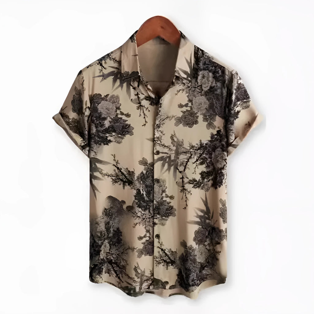 Man's short sleeve Hawaiian print shirt with lapel collar and floral pattern, shown in a casual setting.