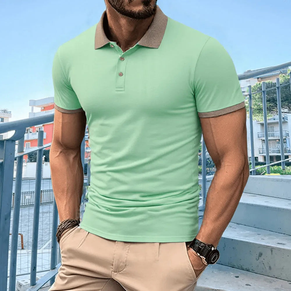 A green ice silk polo shirt with short sleeves and a flocked design on the front, laid flat.