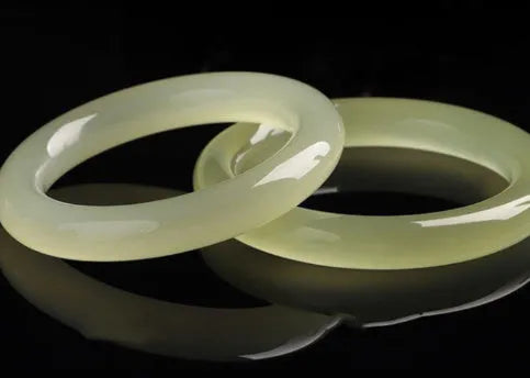 Round bar jade bracelet with winding silk texture showing circular geometry and polished surface