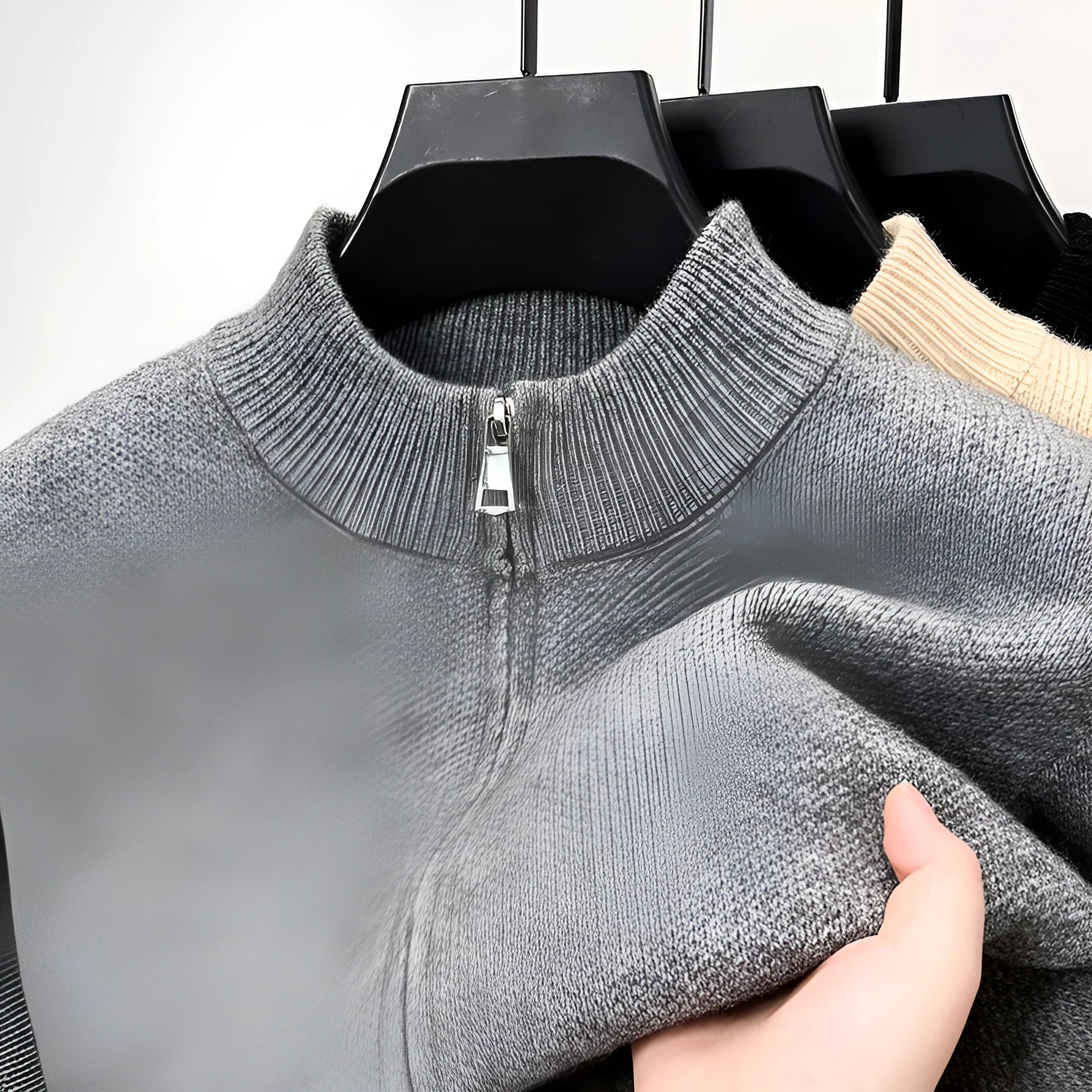 Man wearing a grey stand collar knitted cardigan with a front zipper.