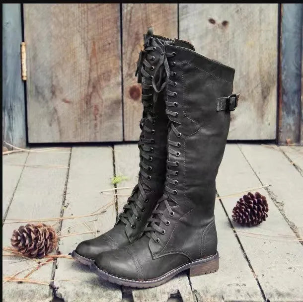 Brown high leg casual boots with a round toe and a chunky low heel on a plain background.
