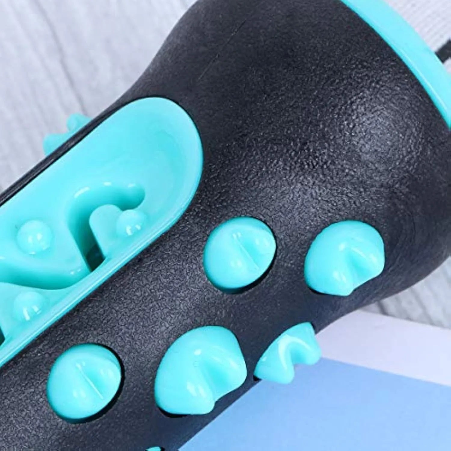 Natural rubber dog dental chew toy with cleaning nubs in blue, green, yellow, and black blue.